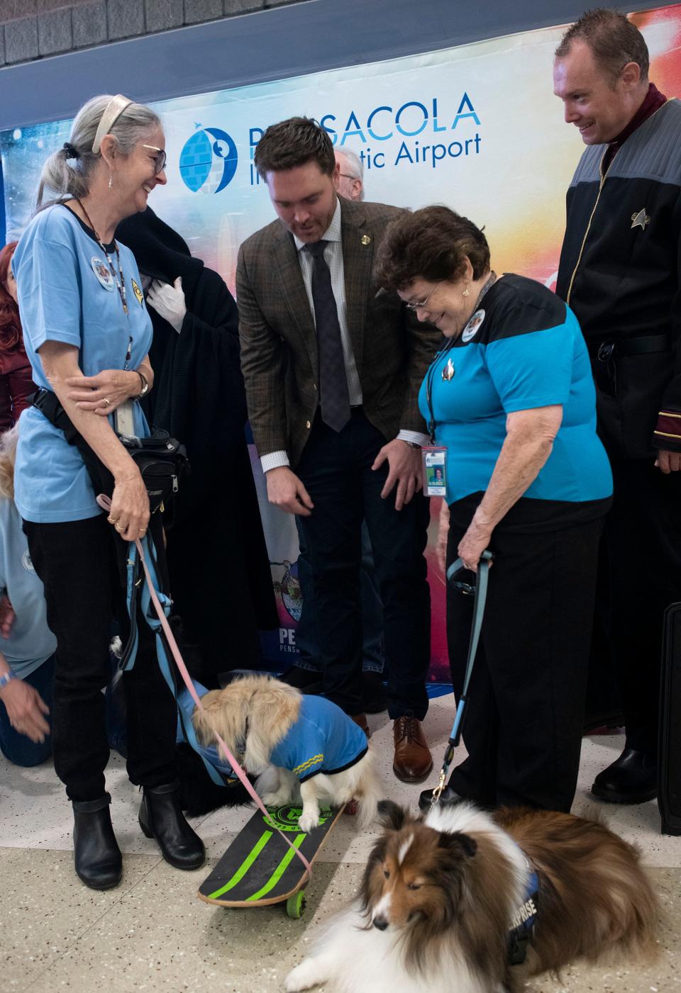 Pensacola Mayor D.C. Reeves meets members of the Starfleet Canine Corps following the ceremonial renaming of the Pensacola International Airport to Pensacola Intergalactic Airport on Tuesday, Feb. 7, 2023. The name change coincides with the Pensacon pop culture convention being held at the Pensacola Bay Center later this month.