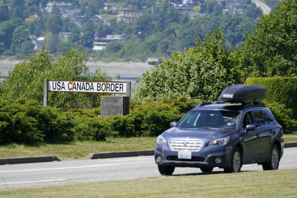 FILE - In this June 8, 2021, file photo, a car heads into the U.S. from Canada at the Peace Arch border crossing in Blaine, Wash. Canada is lifting its prohibition Monday, Aug. 9, on Americans crossing the border to shop, vacation or visit, but the United States is keeping similar restrictions in place for Canadians. The reopening Monday is part of a bumpy return to normalcy from COVID-19 travel bans.  (AP Photo/Elaine Thompson, File)