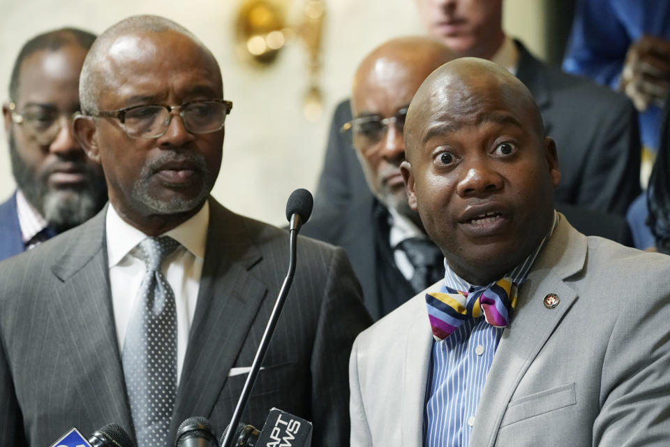 Rep. Robert L. Johnson III, House Minority Leader, left, listens a Sen. Derrick T. Simmons, Senate Minority Leader, addresses reporters following a public hearing by Mississippi House and Senate Democratic Caucuses, to gain a better understanding of the welfare scandal, held at the Capitol in Jackson, Miss., Tuesday, Oct. 18, 2022. (AP Photo/Rogelio V. Solis)