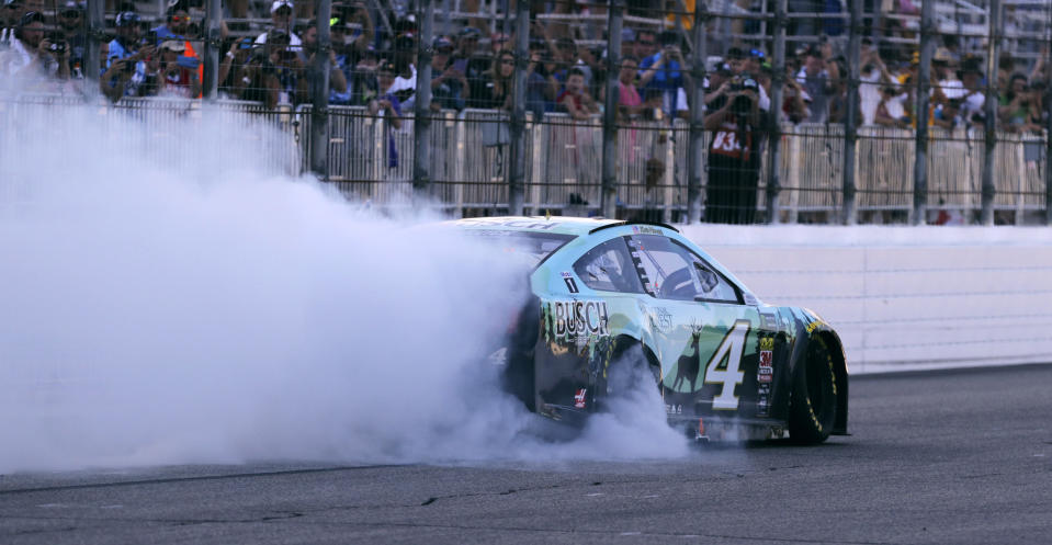 Kevin Harvick smokes his tires for fans after winning a NASCAR Cup Series auto race at New Hampshire Motor Speedway in Loudon, N.H., Sunday, July 21, 2019. (AP Photo/Charles Krupa)