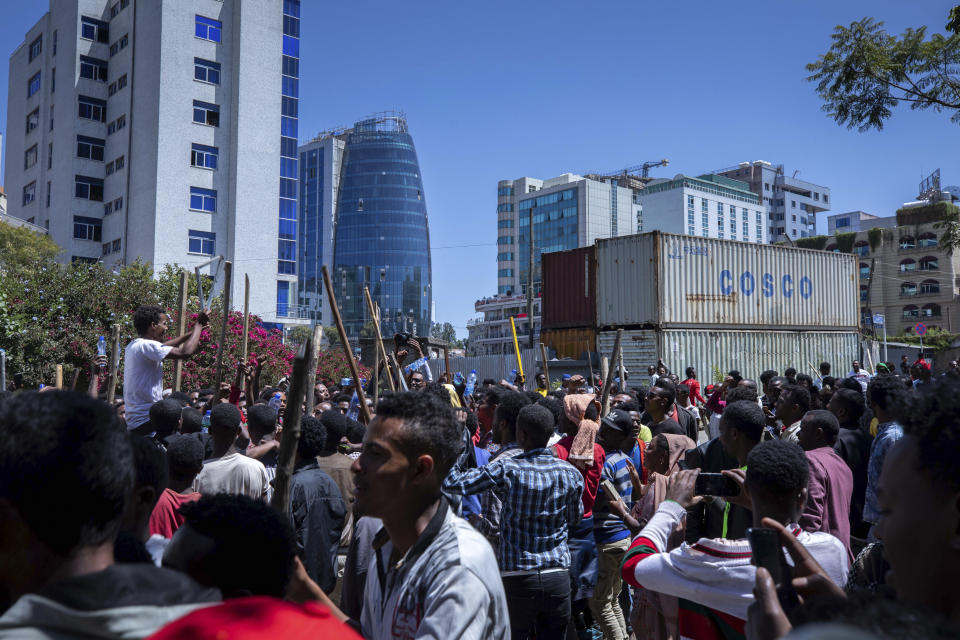 A group of supporters shout slogans at the house of opposition leader Jawar Mohammed to show their support, in Addis Ababa, Ethiopia, Thursday Oct. 24, 2019. Ethiopia’s Nobel Peace Prize-winning prime minister Abiy Ahmed faced the most serious political challenge of his short rule Thursday as officials said dozens of people might be dead in two days of unrest, and Jawar Mohammed hinted that he might enter next year’s election race to challenge Abiy to become Prime Minister.(AP photo Mulugeta Ayene)