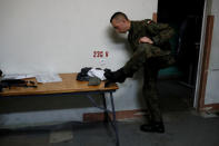 A recruit cleans his shoes after exercises during his 16-day basic training for Poland's Territorial Defence Forces, at a military unit in Siedlce, Poland, December 7, 2017. REUTERS/Kacper Pempel/Files