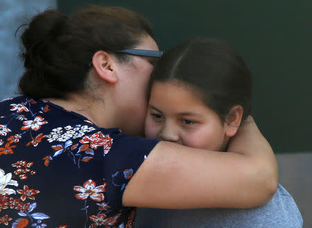 REFILE -- CORRECTING TYPO -- A student who was evacuated after a shooting at North Park Elementary School is embraced after groups of them were reunited with parents waiting at a high school in San Bernardino, California, U.S. April 10, 2017. REUTERS/Mario Anzuoni