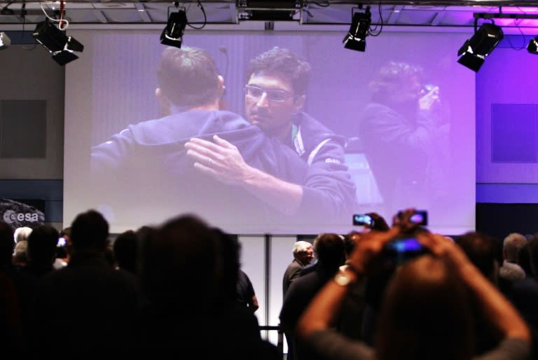 Engineers and scientists react in the main control room of the European Space Operation Center (ESOC) in Darmstadt, Germany on September 30, 2016 after the controlled crash-landing of space probe Rosetta onto the surface of a comet