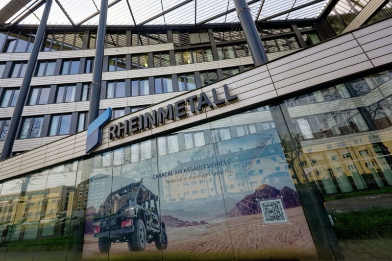 The Rheinmetall AG logo can be seen on the facade of an administration building. Henning Kaiser/dpa