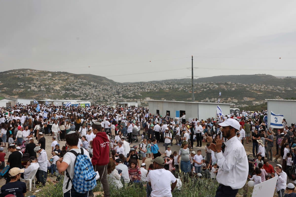 Israeli settlers listen to a speech by their far-right national security minister during a rally in the outpost of Eviatar (AFP via Getty Images)