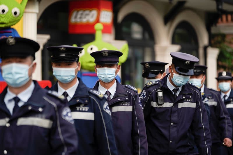 Security staff wear face masks at Shanghai Disney Resort as the Shanghai Disneyland theme park reopens following a shutdown due to the coronavirus disease (COVID-19) outbreak, in Shanghai