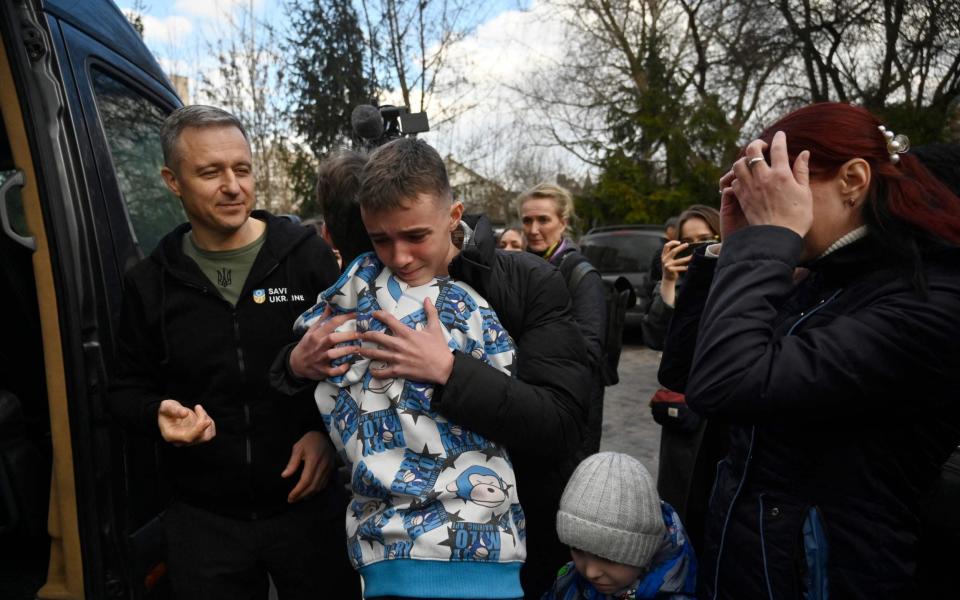 Inessa with her son Vitaly who was one of 16,000 children taken - SERGEI CHUZAVKOV/AFP