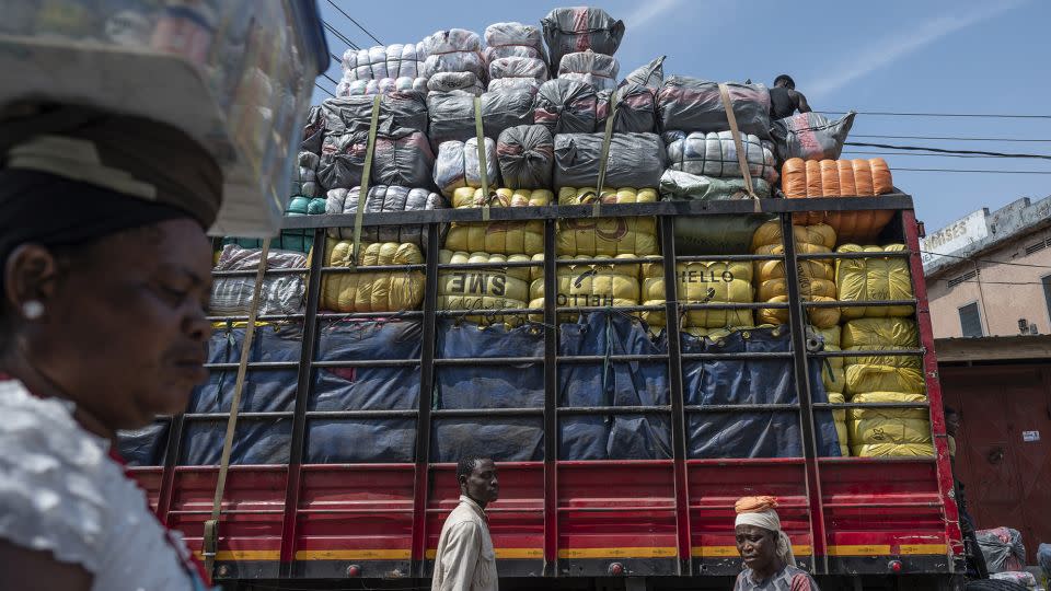 Bales of second-hand garments are brought into the Kantamanto textile market in Accra, Ghana, in September, 2022. Almost half is not fit to sell and ends up in landfill. - Andrew Caballero-Reynolds/Bloomberg/Getty Images