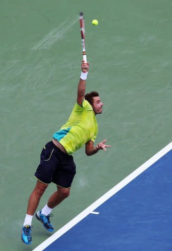 Stanislas Wawrinka of Switzerland serves against Roger Federer of Switzerland. Federer won 7-6 (7/4), 6-3