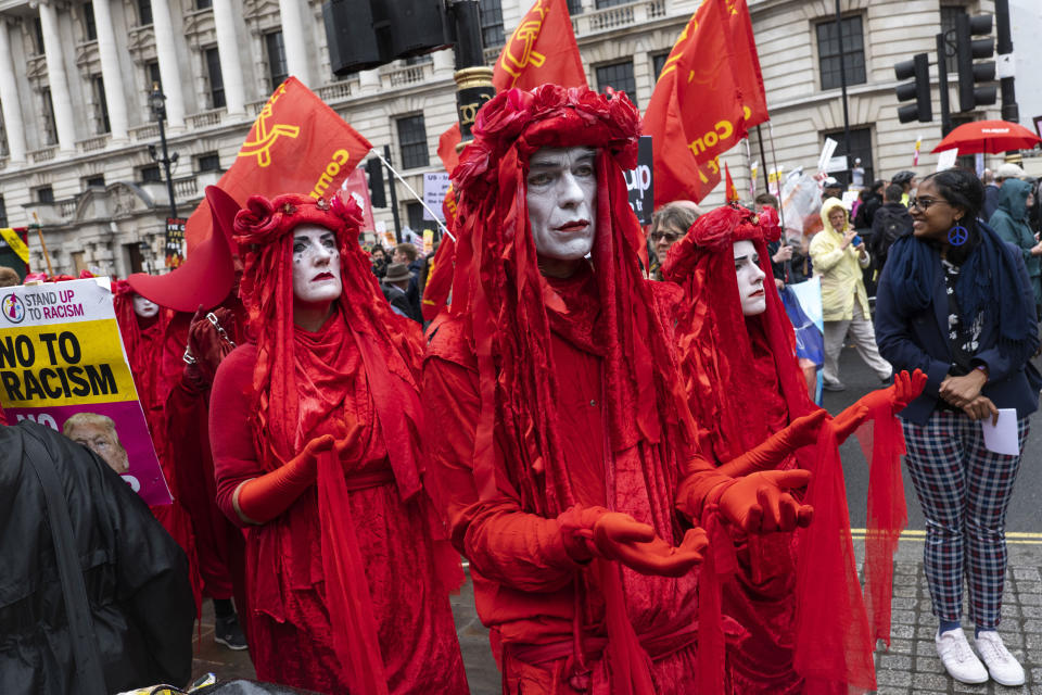 Mime artists dressed in red with white face paint during a demonstration against U.S. President Donald Trump's state visit to the U.K. (Photo: Sam Mellish / In Pictures via Getty Images)