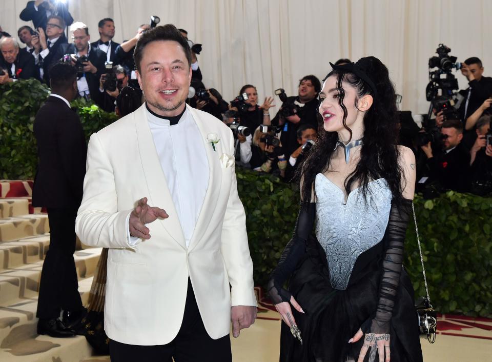 Elon Musk and Grimes arrive for the 2018 Met Gala on May 7, 2018, at the Metropolitan Museum of Art in New York. - The Gala raises money for the Metropolitan Museum of Arts Costume Institute. The Gala's 2018 theme is Heavenly Bodies: Fashion and the Catholic Imagination. (Photo by ANGELA WEISS / AFP)        (Photo credit should read ANGELA WEISS/AFP via Getty Images)