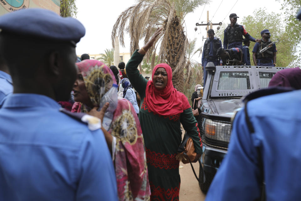 Family members of ousted Sudanese President Omar al-Bashir, who is on trial along with 27 co-accused, protest outside a courthouse in Khartoum, Sudan, Tuesday, July 21, 2020. The 76-year-old al-Bashir has been jailed in Khartoum since his ouster, facing several separate trials related to his rule and the uprising that helped oust him. Al-Bashir is also wanted by the International Criminal Court on charges of war crimes and genocide linked to the Darfur conflict in the 2000s. (AP Photo/Marwan Ali)