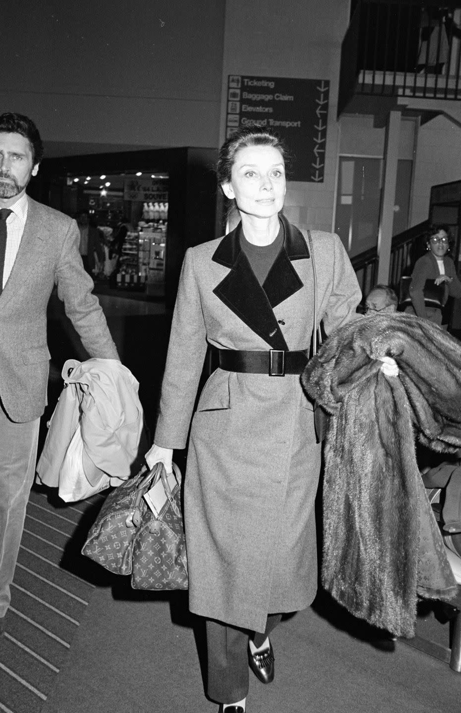 <p>A Louis Vuitton bag is often the go-to airport carry-on for celebrities, but it was particularly chic when Audrey Hepburn did it in '84. </p>