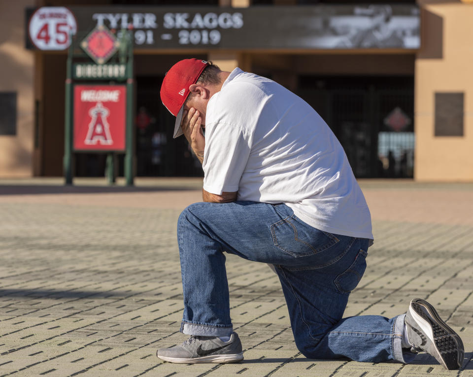 Karl Arriola, 48, of Santa Ana grieves at the site of an makeshift memorial for Angel pitcher Tyler Skaggs outside Angel Stadium in Anaheim on Monday, July 1, 2019. Tyler Skaggs died in Texas at the age of 27. (Photo by Leonard Ortiz/MediaNews Group/Orange County Register via Getty Images)