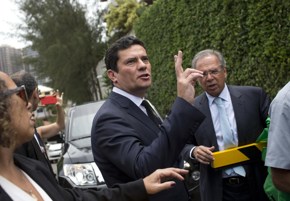 Judge Sergio Moro talks to the press as he exits a meeting with President-elect Jair Bolsonaro, outside Bolsonaro's home in Rio de Janeiro, Brazil, Thursday, Nov. 1, 2018. Bolsonaro has said he wants Moro to be justice minister or to fill the next vacancy on the Supreme Federal Tribunal, Brazil's top court. Moro told the AP in a statement earlier this week he was honored and considering the possibilities. (AP Photo/Silvia Izquierdo)