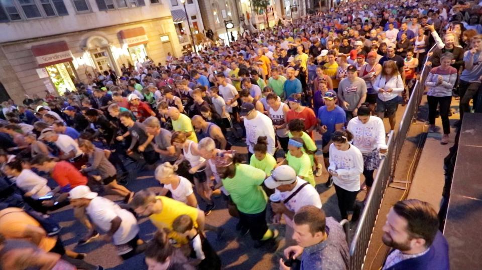 Thousands of people gather at the start of the 2019 Storm the Bastille 5K run and walk in Milwaukee. The run, which began at 9 p.m. at the corner of North Jackson and East Wells streets featured thousands of runners as a kickoff to Bastille Days, Milwaukee's French-themed street festival in the East Town neighborhood around Cathedral Square Park.