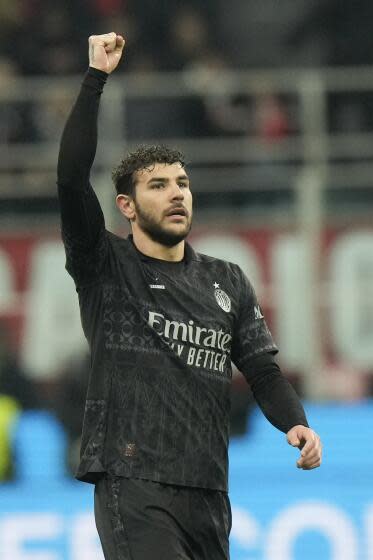 AC Milan's Theo Hernandez celebrates after scoring his side's first goal during a Serie A soccer match between AC Milan and Napoli, at the San Siro stadium in Milan, Italy, Sunday, Feb. 11, 2024. (AP Photo/Luca Bruno)