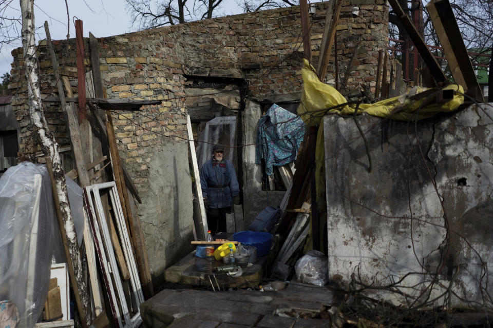 Oleh Mnozhynska, 82, stands in his house destroyed by an airstrike, in Irpin, Ukraine, Sunday, Feb. 26, 2023. (AP Photo/Thibault Camus)