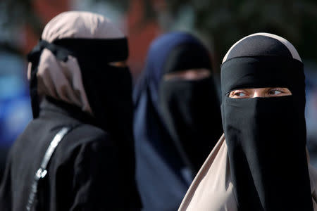 Women in niqabs gather before a demonstration against the Danish face veil ban in Copenhagen, Denmark, August 1, 2018. REUTERS/Andrew Kelly