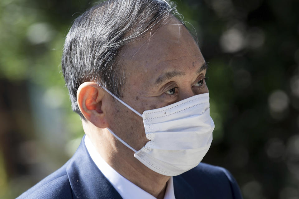 Japan's Prime Minister Yoshihide Suga arrives for a working session at the G7 summit in Cornwall, England, Saturday June 12, 2021. (Brendan Smialowski/Pool via AP)