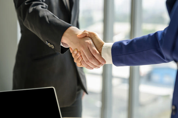 Two piece in suits shaking hands