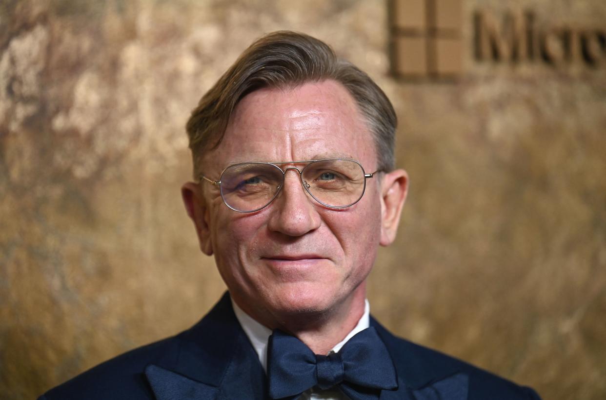 Daniel Craig, sporting a new longer hairstyle and wearing a navy suit and bowtie, arrives for The Albies hosted by the Clooney Foundation