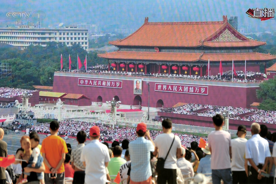 People watch on a giant screen broadcasting the military parade marking the 70th founding anniversary of People's Republic of China, on its National Day at a square in Yichang, Hubei province, China October 1, 2019. (Photo: Stringer/Reuters)