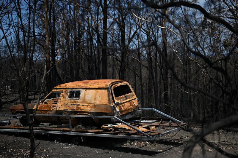 A burnt car destroyed in the recent bushfires is pictured in Conjola Park