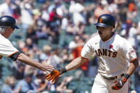 San Francisco Giants' LaMonte Wade Jr., right, is congratulated by third base coach Ron Wotus, left, as he rounds the bases after hitting a solo home run against the Los Angeles Angels during the fifth inning of a baseball game Monday, May 31, 2021, in San Francisco. (AP Photo/Tony Avelar)