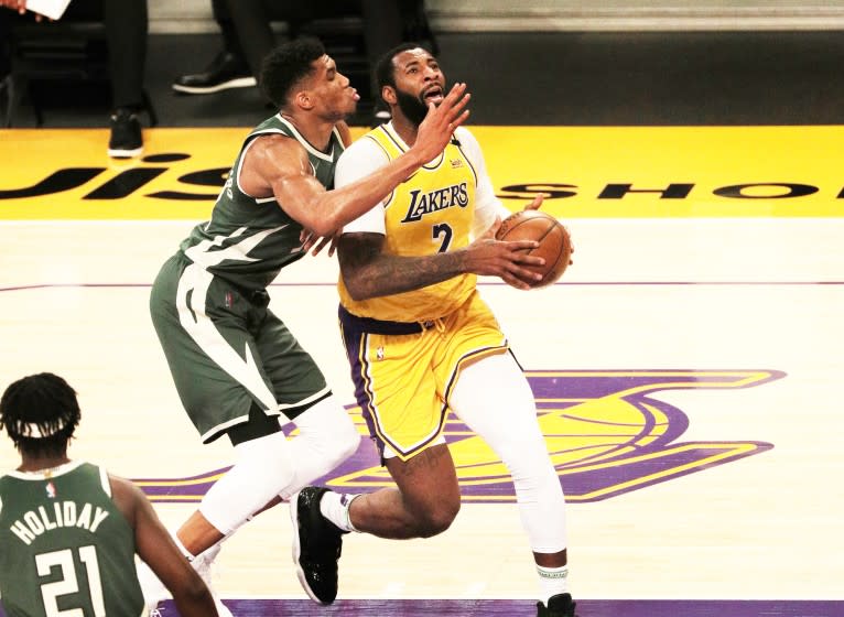 Lakers Andre Drummond (2) drives to the basket against Milwaukee Bucks forward Giannis Antetokounmpo.