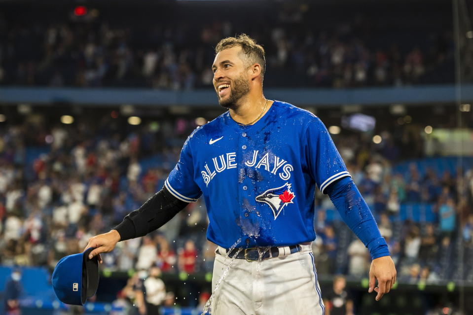 Toronto Blue Jays center fielder George Springer (4) reacts after being doused with ice water after the Blue Jays defeated the St. Louis Cardinals 10-3 in a baseball game, Tuesday, July 26, 2022 in Toronto. (Christopher Katsarov/The Canadian Press via AP)