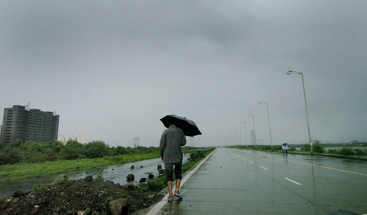 A Mumbai resident makes his way home along the deserted Wadala highway (AFP via Getty Images)
