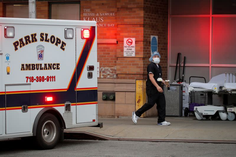 A healthcare worker is seen outside the emergency center at Maimonides Medical Center during the outbreak of the coronavirus disease (COVID19) in the Brooklyn, New York