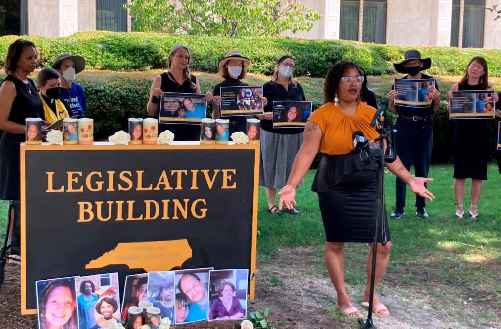 Courtney Crudup, 32, of Oxford, N.C., speaks on Tuesday, July 26, 2022, outside the North Carolina Legislative Building in Raleigh, N.C., at a news conference and vigil highlighting people who have died while lacking health insurance and urging lawmakers to expand Medicaid in the state. (AP Photo/Gary D. Robertson).