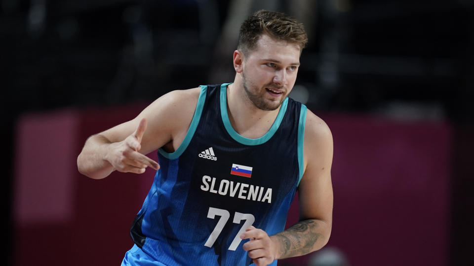 Slovenia's Luka Doncic (77) celebrates after three point basket during men's basketball preliminary round game against Argentina at the 2020 Summer Olympics, Monday, July 26, 2021, in Saitama, Japan. (AP Photo/Charlie Neibergall)