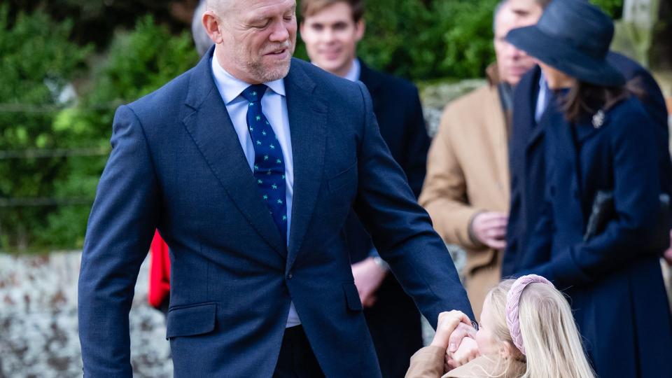 Lena plays with her Dad on the way to church at Sandringham