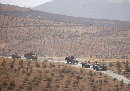 Turkish armoured military vehicles patrol on the Turkish-Syrian border line in Reyhanli, Hatay province, Turkey, October 8, 2017. REUTERS/Osman Orsal