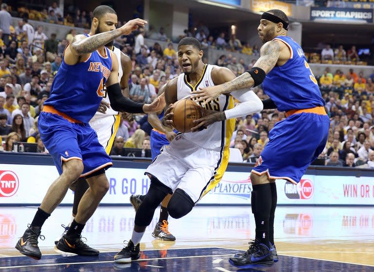 New York Knicks' Tyson Chandler (L) and Kenyon Martin try to block Paul George (C) of the Indiana Pacers on May 14, 2013. The Indiana Pacers are on the brink of advancing to the NBA semi-finals after beating New York 93-82