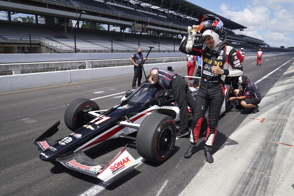 Rinus VeeKay, of the Netherlands, takes off his helmet during qualifications for the Indianapolis 500 auto race at Indianapolis Motor Speedway, Sunday, Aug. 16, 2020, in Indianapolis. (AP Photo/Darron Cummings)