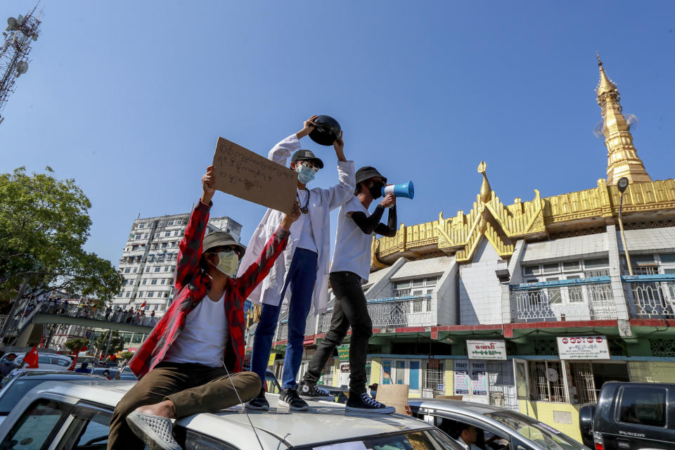 A demonstrator displays an upside-down begging-bowl, a form of protest symbolizing the refusal to receive charity from the military government during a protest in Yangon, Myanmar Wednesday, Feb. 10, 2021. Protesters continued to gather Tuesday morning in Yangon breaching Myanmar's new military rulers ban of public gathering of five or more issued on Monday intended to crack down on peaceful public protests opposing their takeover. (AP Photo)