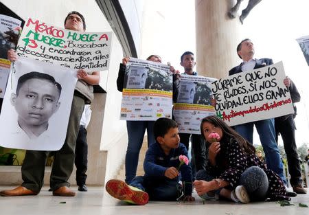 Students holding placards take part in a protest in support of the 43 missing students of the Ayotzinapa teachers' training college Raul Isidro Burgos, outside the Mexican Embassy in Bogota November 7, 2014. REUTERS/John Vizcaino