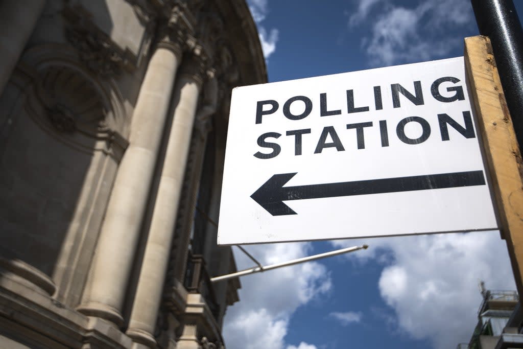 Signage outside a polling station in central Westminster (PA) (PA Wire)