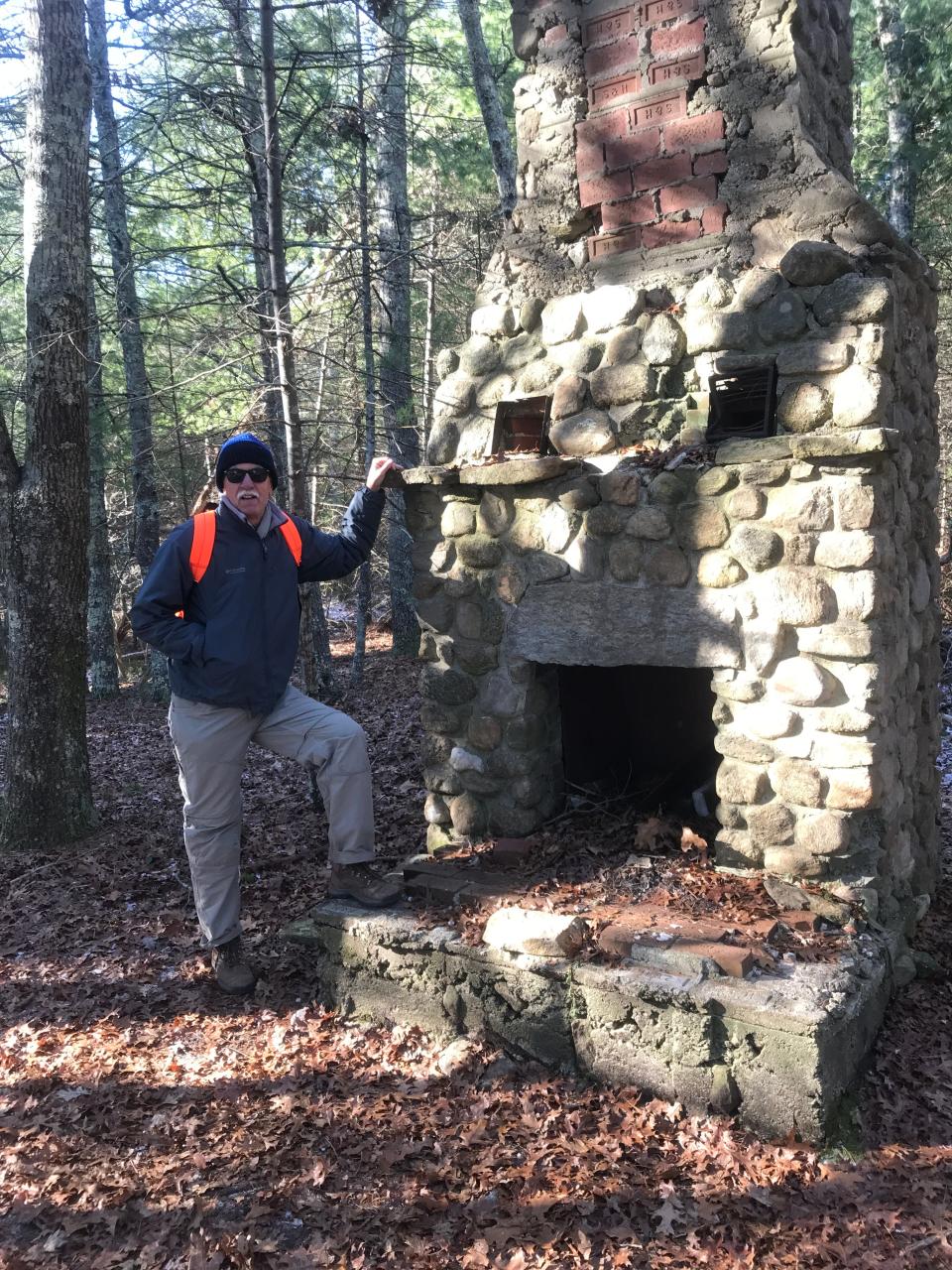 John Kostrzewa, at the decaying stone chimney on the banks of Carr Pond in the Maxwell Mays Wildlife Refuge.