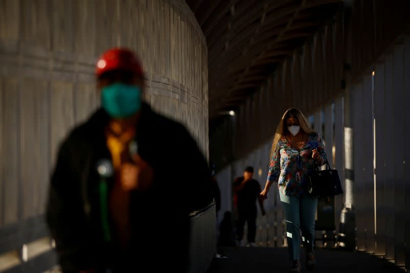 FILE PHOTO: A woman walks towards the U.S. at the Paso del Norte International Border bridge, in Ciudad Juarez