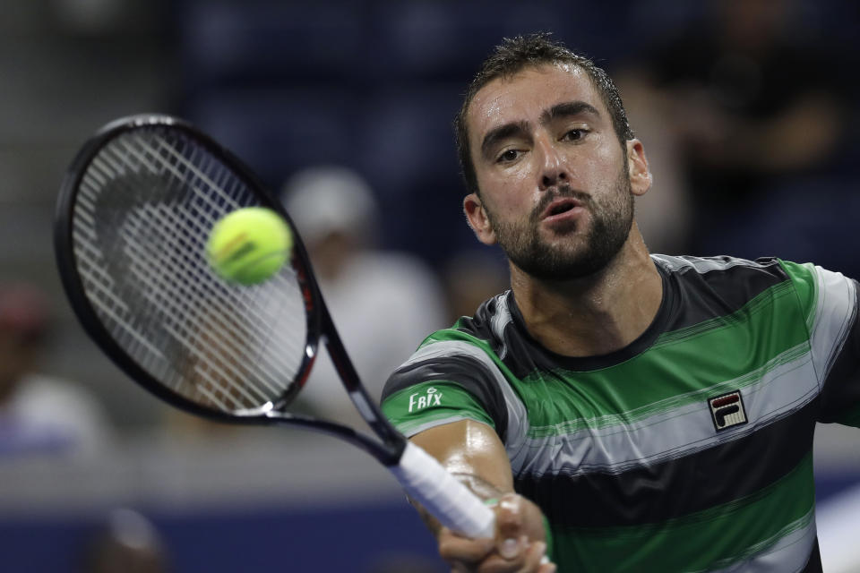 Marin Cilic, of Croatia, returns a shot against Alex de Minaur, of Australia, in a third-round tennis at the U.S. Open tennis championship, Saturday, Sept. 1, 2018, in New York. (AP Photo/Mark Lennihan)