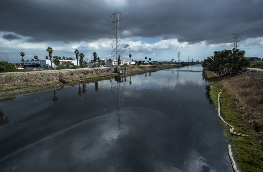 CARSON, CA - OCTOBER 11, 2021: Overall, shows the Dominguez Channel in Carson as seen from Avalon Blvd. A foul odor is emanating from the Dominguez Channel and public health officials are recommending Carson residents keep their doors and windows closed as authorities work to address the odor. The Dominguez Channel is a drain channel that crosses through industrial areas on its way to the Port of Los Angeles. (Mel Melcon / Los Angeles Times)