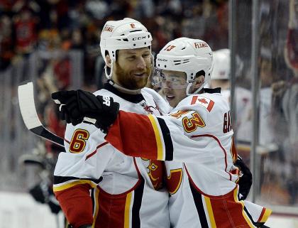 ANAHEIM, CA - MAY 10:  Johnny Gaudreau #13 of the Calgary Flames celebrates his goal with Dennis Wideman #6 in Game Five of the Western Conference Semifinals during the 2015 Stanley Cup Playoffs at Honda Center on May 10, 2015 in Anaheim, California. (Photo by Kevork Djansezian/Getty Images)