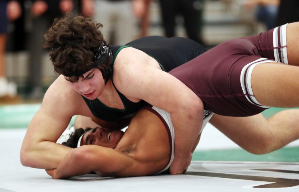 Rocco Lore from Yorktown and Reese Almonte from Ossining wrestle in the 215-pound weight class during the Section 1 Division I Dual Meet Tournament at Yorktown High School Dec. 21, 2023. Lore won the match.