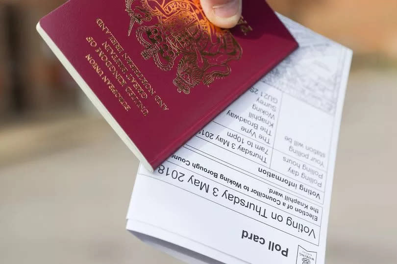 A voter carries his passport along with his poll card